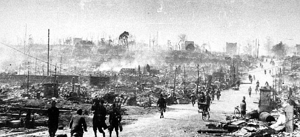 Photograph of Japanese on a road through Tokyo taken some time after the March 1945 U.S. firebombing of the city. 