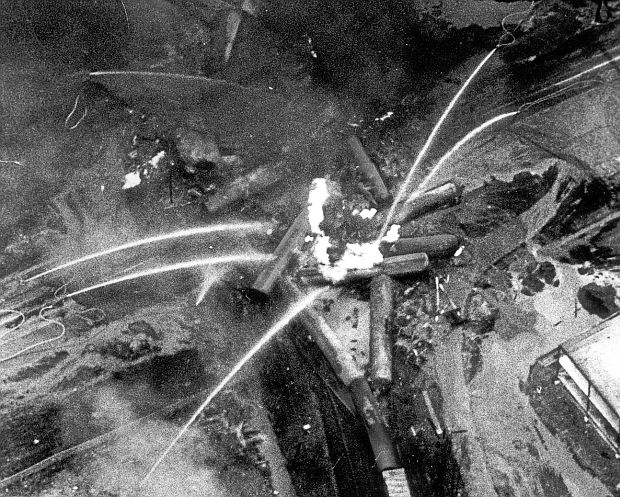 An aerial view of the November 1979 Canadian Pacific derailment at Mississauga, Ontario, at the Mavis Road cross-street, showing the conflagration of various piled-up tanker cars on fire (white color) as numerous streams of firefighting water poured on the blazing tank cars.  