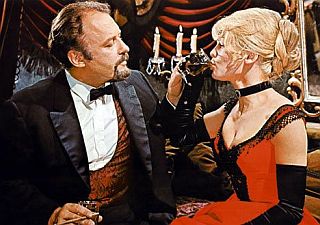 Komarovsky, in his secret affair with Lara, dresses her in clothes of his liking, takes her dancing, and plies her with food and drink.