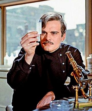 Young medical doctor, Yuri Zhivago in Moscow, examining a slide specimen at a medical bench with microscope.