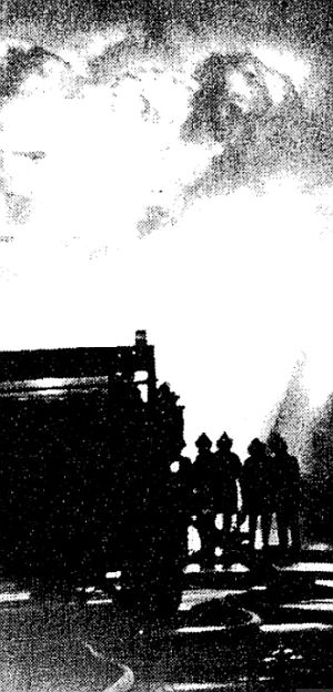 Part of an April 22, 1980 NY Times photo showing silhouetted fire fighters against a burning inferno and roiling sky at the Chemical Control Co. toxic blaze in Elizabeth, NJ.