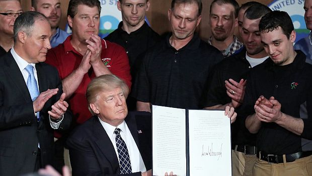 President Trump, with Scott Pruitt at left and a contingent of coal miners present, signs an executive order on March 28, 2017  to begin the process of overturning former president Barack Obama's and EPA’s Clean Power Plan to reduce climate-damaging fossil fuel emissions. 
