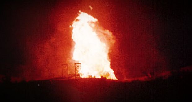 August 2000 explosion & fire of El Paso Natural Gas pipeline in New Mexico that killed 12 people. At lower left of towering fireball flame, the feint outlines of the two 85-foot-tall suspension bridge structures can be seen.